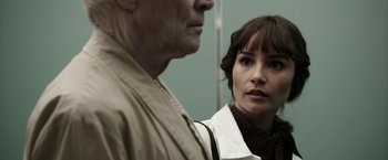 Movie still from “Insidious: Chapter 2” (2013), directed by James Wan – A man and a woman standing next to each other; Close Up shot, Over the shoulder angle