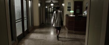 Movie still from “Insidious: Chapter 2” (2013), directed by James Wan – A woman walking down the hall way of a building; Wide shot, High angle