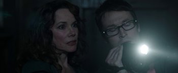 Movie still from “Insidious: Chapter 2” (2013), directed by James Wan – A man and a woman looking at something in the dark; Close Up shot, Over the shoulder angle