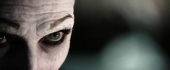 Movie still from “Insidious: Chapter 2” (2013), directed by James Wan – View of a woman's eye with green eyes; Extreme Close Up shot, Low angle