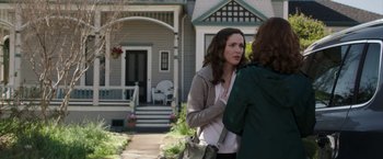 Movie still from “Insidious: Chapter 2” (2013), directed by James Wan – Two women standing in front of a house talking; Medium shot, Over the shoulder angle