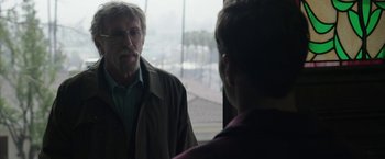 Movie still from “Insidious: Chapter 2” (2013), directed by James Wan – An older man and a younger man are looking at one another in the mirror; Close Up shot, Over the shoulder angle