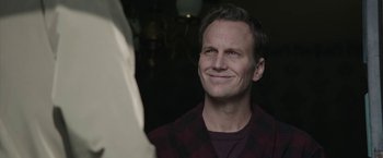 Movie still from “Insidious: Chapter 2” (2013), directed by James Wan – A person wearing a plaid shirt; Close Up shot, Over the shoulder angle