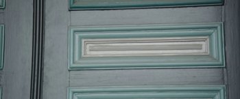 Movie still from “Insidious: Chapter 2” (2013), directed by James Wan – View of a green and white painted door; Extreme Close Up shot, Overhead angle