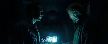 Movie still from “Insidious: Chapter 2” (2013), directed by James Wan – Two men are looking at each other in the dark; Medium shot, Over the shoulder angle
