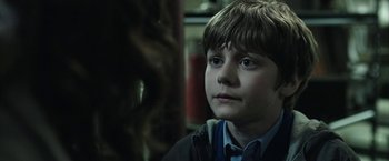 Movie still from “Insidious: Chapter 2” (2013), directed by James Wan – A young boy is looking into the distance; Close Up shot, Over the shoulder angle