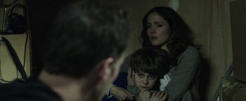 Movie still from “Insidious: Chapter 2” (2013), directed by James Wan – A woman and a boy looking at a man in a mirror; Close Up shot, Over the shoulder angle