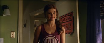 Movie still from “Insidious: Chapter 3” (2015), directed by Leigh Whannell – A young woman standing in front of a warning sign; Medium shot, Over the shoulder angle