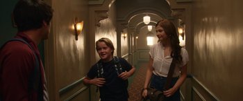 Movie still from “Insidious: Chapter 3” (2015), directed by Leigh Whannell – A boy and a girl walking down a hall way; Medium shot, Over the shoulder angle