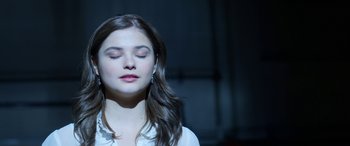 Movie still from “Insidious: Chapter 3” (2015), directed by Leigh Whannell – A young woman with her eyes closed with her eyes closed; Close Up shot, High angle