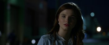 Movie still from “Insidious: Chapter 3” (2015), directed by Leigh Whannell – A beautiful young woman with long brown hair and blue eyes; Close Up shot, Over the shoulder angle