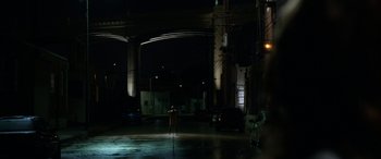 Movie still from “Insidious: Chapter 3” (2015), directed by Leigh Whannell – A person standing in a dark room with lights on; Extreme Wide shot, Over the shoulder angle