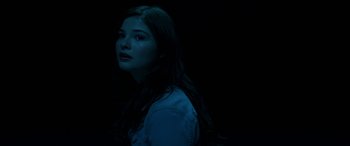 Movie still from “Insidious: Chapter 3” (2015), directed by Leigh Whannell – A woman with long dark hair standing in the dark; Close Up shot, High angle