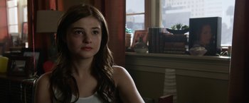 Movie still from “Insidious: Chapter 3” (2015), directed by Leigh Whannell – A young woman sitting in front of a window; Close Up shot, Over the shoulder angle