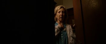 Movie still from “Insidious: Chapter 3” (2015), directed by Leigh Whannell – An older woman looking in the mirror in front of a mirror; Close Up shot, Low angle