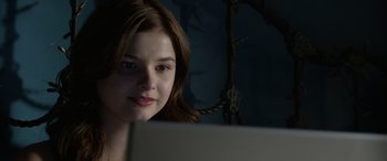 Movie still from “Insidious: Chapter 3” (2015), directed by Leigh Whannell – A woman sitting in front of a laptop computer; Close Up shot, Over the shoulder angle