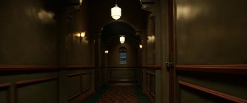 Movie still from “Insidious: Chapter 3” (2015), directed by Leigh Whannell – A dark hallway with a window and lights on; Wide shot, High angle