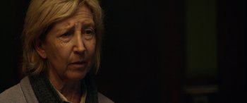 Movie still from “Insidious: Chapter 3” (2015), directed by Leigh Whannell – An older woman is looking at the camera; Close Up shot, Over the shoulder angle