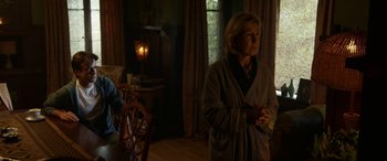 Movie still from “Insidious: Chapter 3” (2015), directed by Leigh Whannell – An older woman standing in a living room; Medium shot, Low angle
