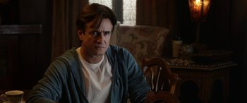 Movie still from “Insidious: Chapter 3” (2015), directed by Leigh Whannell – A man sitting in a chair in a room; Close Up shot, Over the shoulder angle