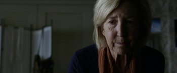 Movie still from “Insidious: Chapter 3” (2015), directed by Leigh Whannell – An older woman is looking at the camera; Close Up shot, Over the shoulder angle