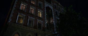 Movie still from “Insidious: Chapter 3” (2015), directed by Leigh Whannell – A building that has a fire escape on the side of it; Extreme Wide shot, Low angle