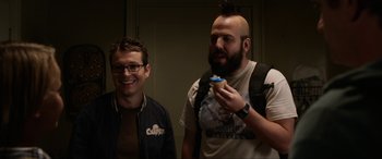 Movie still from “Insidious: Chapter 3” (2015), directed by Leigh Whannell – Two men standing next to each other and one is eating a cupcake; Close Up shot, Over the shoulder angle