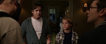 Movie still from “Insidious: Chapter 3” (2015), directed by Leigh Whannell – A man standing next to a young boy in a kitchen; Medium shot, Over the shoulder angle