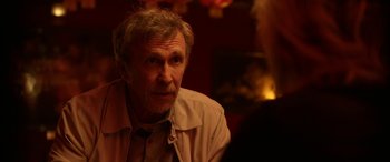 Movie still from “Insidious: Chapter 3” (2015), directed by Leigh Whannell – An older man sitting in front of a fireplace; Close Up shot, Over the shoulder angle