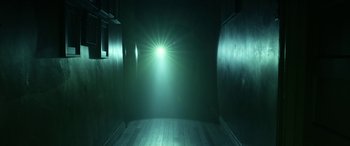 Movie still from “Insidious: Chapter 3” (2015), directed by Leigh Whannell – A light shining in a dark room with a brick floor; Extreme Wide shot, Low angle