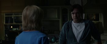 Movie still from “Insidious: Chapter 3” (2015), directed by Leigh Whannell – A man and a woman in a kitchen talking to each other; Medium shot, Over the shoulder angle