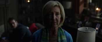 Movie still from “Insidious: Chapter 3” (2015), directed by Leigh Whannell – An older woman wearing a blue shirt and a green and blue scarf; Close Up shot, Over the shoulder angle