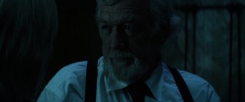 Movie still from “Insidious: Chapter 3” (2015), directed by Leigh Whannell – An old man with a beard wearing a white shirt; Close Up shot, Low angle