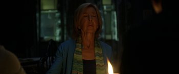 Movie still from “Insidious: Chapter 3” (2015), directed by Leigh Whannell – A woman with her eyes closed is holding a lit candle; Close Up shot, Low angle