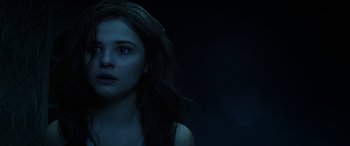 Movie still from “Insidious: Chapter 3” (2015), directed by Leigh Whannell – A woman with long dark hair stares into the distance; Close Up shot, Over the shoulder angle