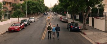 Movie still from “Insidious: Chapter 3” (2015), directed by Leigh Whannell – A group of people walking down a street; Wide shot, High angle