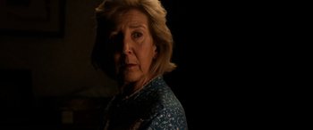 Movie still from “Insidious: Chapter 3” (2015), directed by Leigh Whannell – An older woman is looking at the camera; Close Up shot, Over the shoulder angle