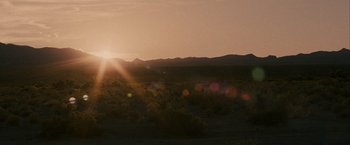 Movie still from “Into the Wild” (2007), directed by Sean Penn – The sun is setting over a desert plain; Extreme Wide shot, Low angle