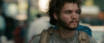 Movie still from “Into the Wild” (2007), directed by Sean Penn – A person with a beard wearing a backpack; Close Up shot, Over the shoulder angle