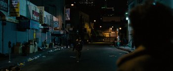 Movie still from “Into the Wild” (2007), directed by Sean Penn – A person walking down a street at night; Extreme Wide shot, High angle