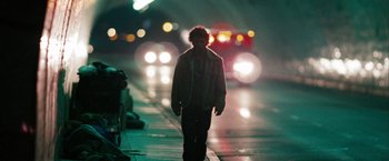 Movie still from “Into the Wild” (2007), directed by Sean Penn – A man walking down a street at night; Wide shot, Low angle