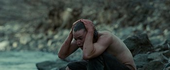 Movie still from “Into the Wild” (2007), directed by Sean Penn – A man sitting on the ground with his hands in his head; Close Up shot, High angle