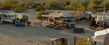 Movie still from “Into the Wild” (2007), directed by Sean Penn – An rv parked in the middle of the desert; Extreme Wide shot, High angle