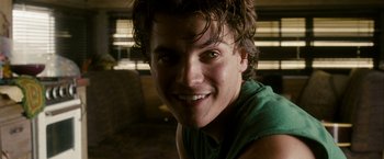 Movie still from “Into the Wild” (2007), directed by Sean Penn – A person with wet hair smiling; Close Up shot, Over the shoulder angle