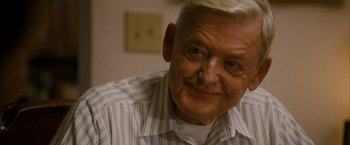 Movie still from “Into the Wild” (2007), directed by Sean Penn – An older man with white hair smiling for the camera; Close Up shot, Over the shoulder angle