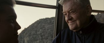 Movie still from “Into the Wild” (2007), directed by Sean Penn – An older man sitting in front of a window; Close Up shot, Low angle