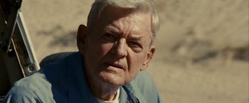 Movie still from “Into the Wild” (2007), directed by Sean Penn – An old man with a white beard and a blue shirt; Close Up shot, Over the shoulder angle