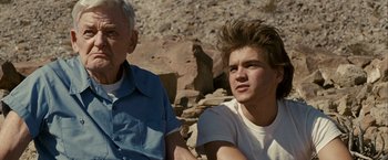 Movie still from “Into the Wild” (2007), directed by Sean Penn – An older man sitting next to a young man; Close Up shot, Over the shoulder angle