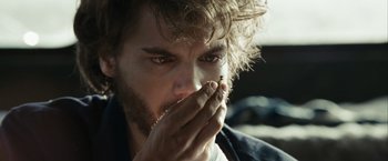 Movie still from “Into the Wild” (2007), directed by Sean Penn – A person holding his hand up to his face; Extreme Close Up shot, Over the shoulder angle