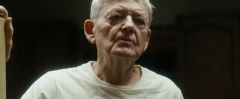 Movie still from “Into the Wild” (2007), directed by Sean Penn – An old man with a white beard and a white shirt; Close Up shot, Low angle